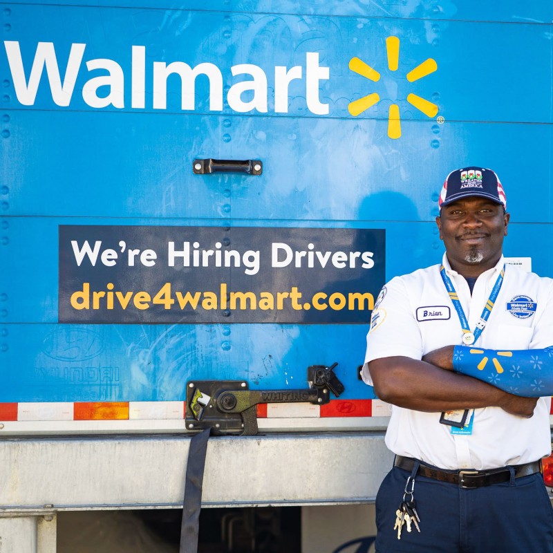 a trucker standing in front of the read door of a truck