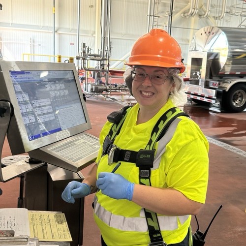Worker standing in front of computer