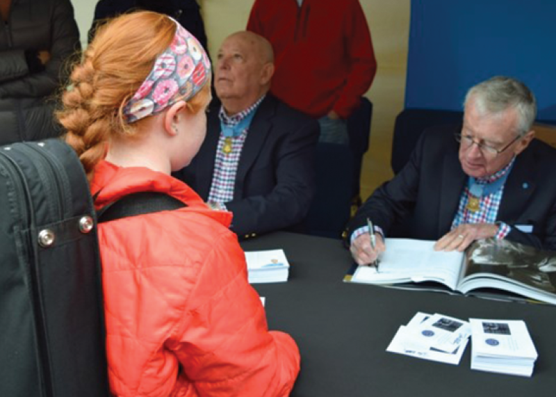 Student has Veteran Sign Her Book