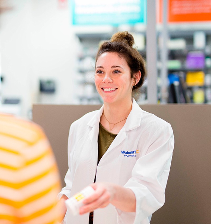 Pharmacy Technician Helping Customers At Walmart