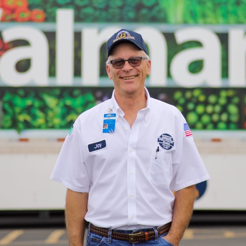 a truck driver standing in front of a truck