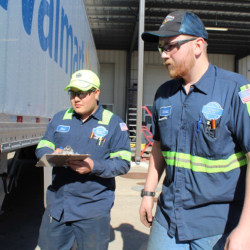 Team inspecting truck exterior